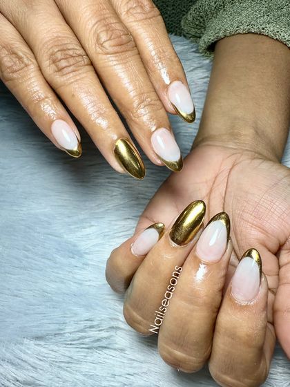 For the client who loves gold. This design features a full-coverage gold chrome accent nail paired with modern gold French tips.