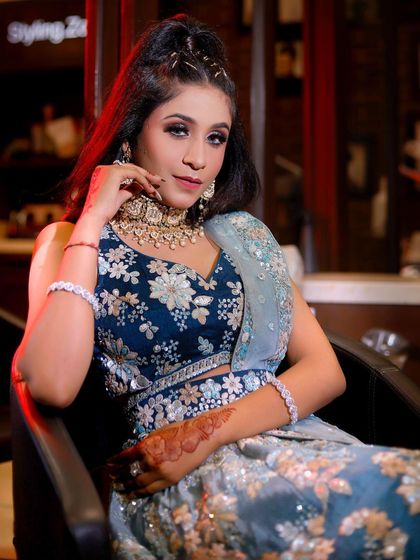 The client is getting her final touches done in the studio, wearing the beautiful teal lehenga. This shows how I help you get ready from head to toe.