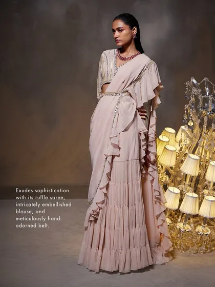 This shot of the Elsa Saree Set highlights its key features: the ruffle saree, embellished blouse, and meticulously adorned belt, all exuding sophistication.