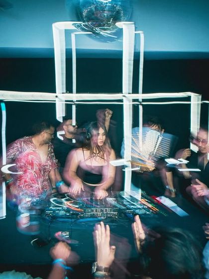 A motion-blur shot capturing the chaotic energy and movement of a wild club night.