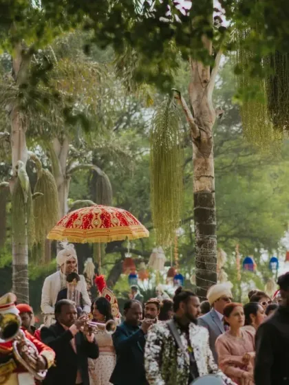 A full baraat procession with a brass band and dancing guests makes its way through the farm venue. I manage the logistics of large-scale processions to ensure they are joyful and seamless.