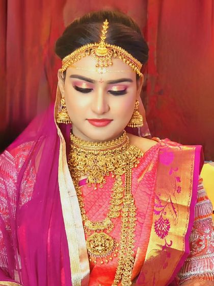 A beautiful bride ready for her `mugurtham`. She is wearing a heavy choker and a long haram in a classic temple design.