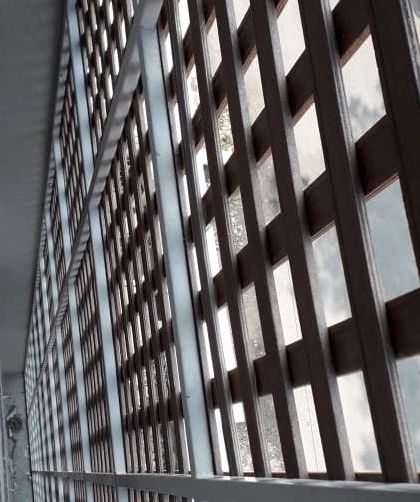 A side view of the Tipwood jaali screen, showing how it is mounted to create a functional and decorative layer over the building's exterior.