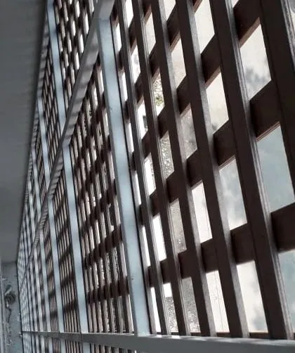 A side view of the Tipwood jaali screen, showing how it is mounted to create a functional and decorative layer over the building's exterior.