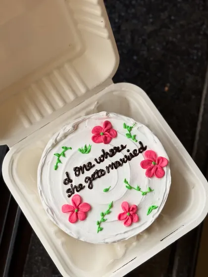 A closer look at the "Friends" themed bento cake for a bride-to-be, showing the delicate floral details.