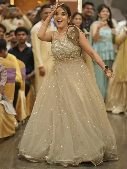 A fun, candid shot of the bride dancing at her engagement. Her modern gown is paired with a chic ponytail and glowing makeup that lasts through the night.