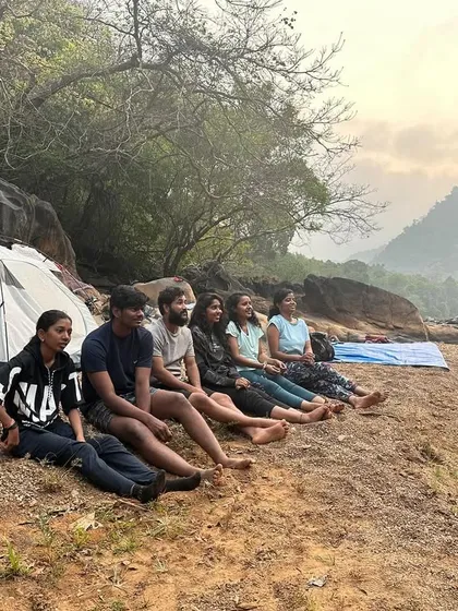 Relaxing by the riverside at our campsite, watching the sunset after a day of trekking.