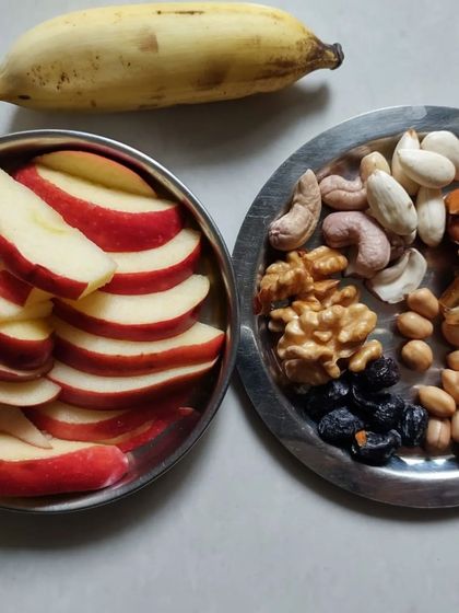 My daily fuel. A plate of soaked nuts, dates, and fresh fruit is a perfect example of a high-energy, yogic diet that supports a day of practice and activity.