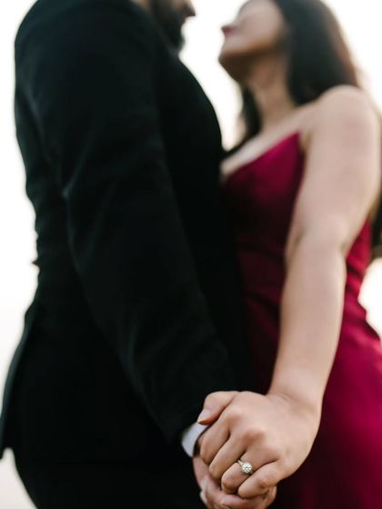 A detail shot focusing on their joined hands and the engagement ring. It’s a beautiful way to symbolize their commitment while keeping the focus on their connection.