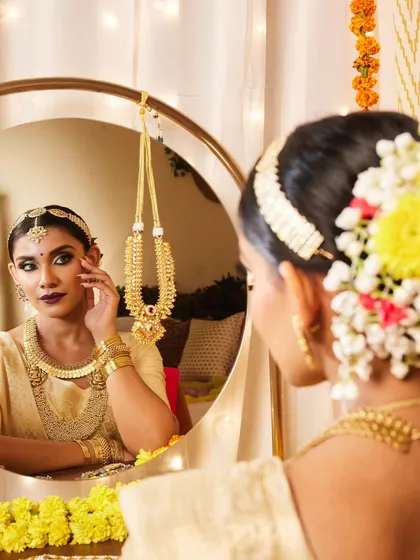 A full view of a traditional South Indian bridal hairstyle. The long braid is adorned with flowers and traditional hair jewelry, creating a look that is rich in culture and incredibly beautiful.
