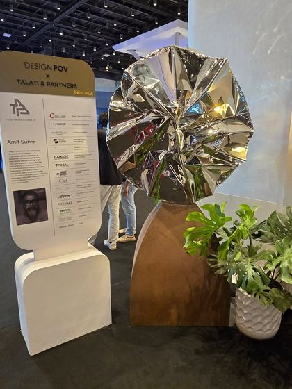 My sculpture "Eclipse" featured at the Design POV exhibition. Its placement next to a plant highlights the contrast between its industrial materials and organic forms.
