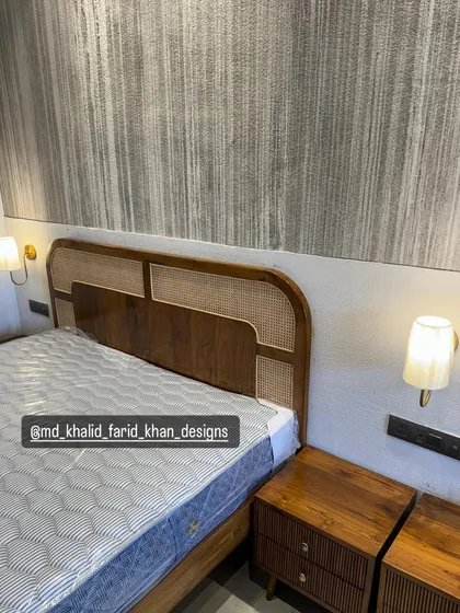 A close-up of the cane and wood headboard in the hotel room.