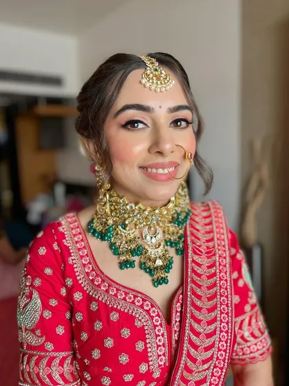The complete look for Akshita, featuring a traditional nose ring and makeup that enhances her natural features.