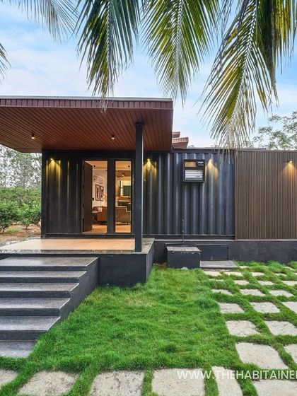 A modern container home with a beautiful porch and landscaped entrance, showing how I blend industrial materials with natural elements.