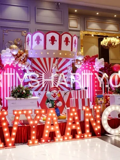 We bring the fun of the fair to you with our spectacular Carnival themes. This setup includes a custom carousel-style backdrop, classic red and white stripes, and personalized marquee letters that create an atmosphere of excitement and wonder.