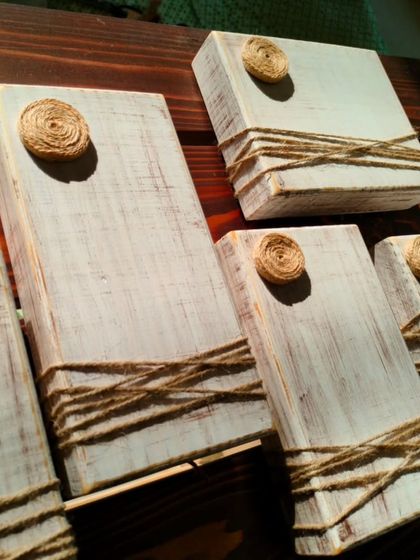 A collection of our wooden photo blocks, ready to be sent to a new home. The distressed white finish and jute-rope detail give them a rustic, timeless appeal.