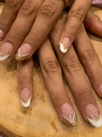 A glamorous take on the French manicure. This design features a classic white tip outlined with a sharp line of gold glitter for a touch of wedding season sparkle.