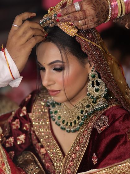 A candid moment from the wedding ceremony. The makeup holds up perfectly, ensuring the bride looks flawless throughout all the rituals and emotional moments.
