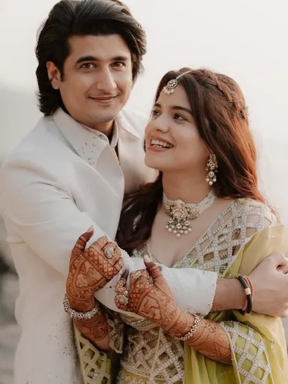 A lovely portrait of the couple embracing, the bride's detailed mehndi adding to her overall look.