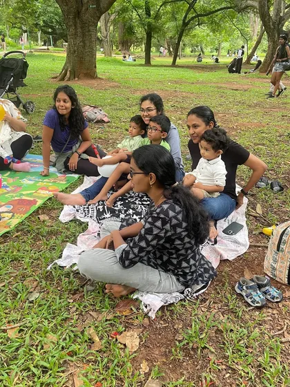 A mother and her children listen in, showcasing the relaxed and inclusive environment of our story circle.