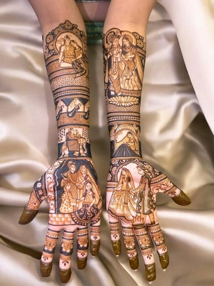 This intricate design tells a complete story across both arms, with portraits of Radha-Krishna, the couple, their family, and even a depiction of a meaningful place. Every part of this mehndi is filled with personal details.