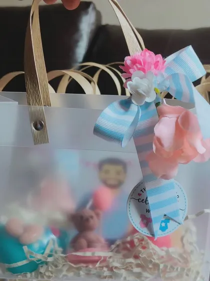 The complete baby shower gift bag, elegantly assembled and ready to be gifted.