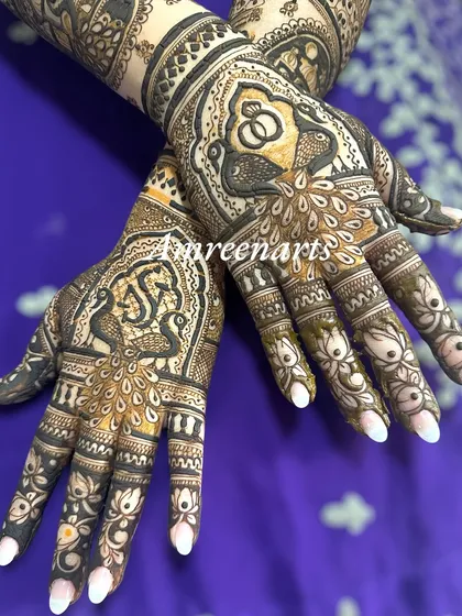 A close-up of the palms, featuring peacock and ring motifs for an engagement ceremony.