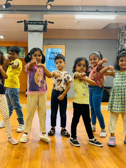 The kids showing off their power poses. We teach them to dance with strength and confidence.