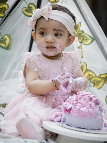 The pure joy and delightful mess of a first birthday cake smash. I love capturing a child's personality as they explore, and these fun, playful shots are always a family favorite.