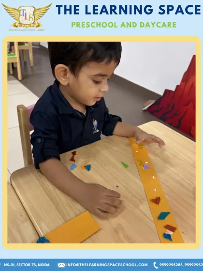 A young boy carefully decorates his headband. This activity requires focus and develops fine motor skills, all while learning about American cultural heritage.