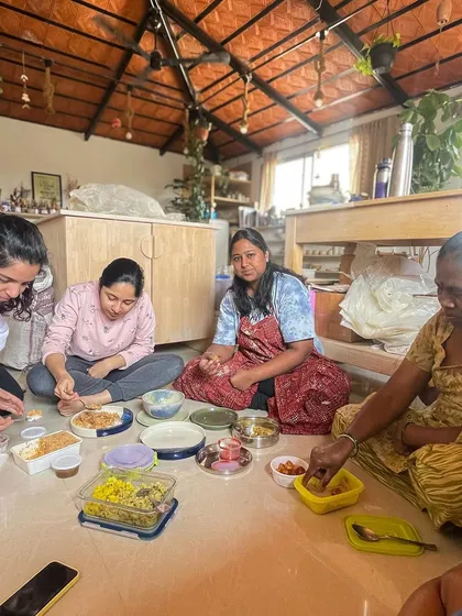 A candid moment of community as students and I share a meal together on the studio floor, surrounded by our work and shared stories.