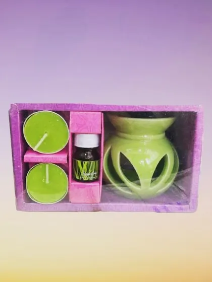 This is our complete ceramic oil burner gift set, perfect for anyone new to aromatherapy. It includes a lovely green ceramic burner, two matching tealight candles, and a bottle of our refreshing lemongrass aroma oil, all packed in a beautiful box.
