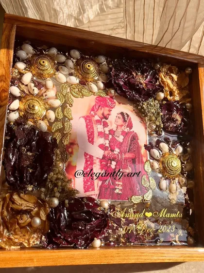 This teakwood frame is a stunning example of preserving kaleera and varmala together. The golden kaleera elements and deep red flowers create a regal and timeless piece.