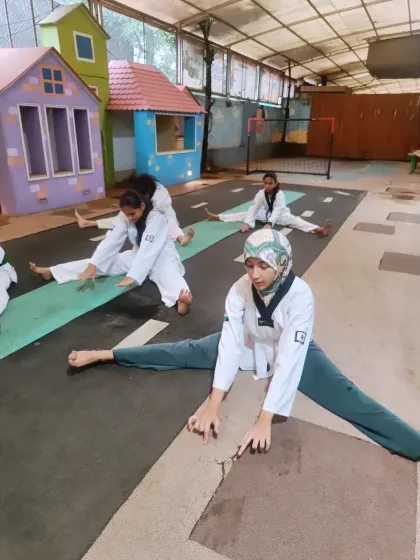 This student demonstrates excellent form in her center split stretch. This dedication to flexibility is what allows our martial artists to perform such impressive kicks.