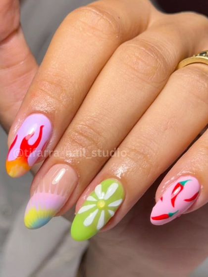 A close-up of the vibrant, mismatched set, showing the hand-painted flames, flower, and chili designs.