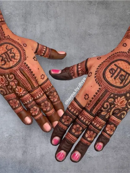 This design is a simple yet powerful tribute to parents, with 'Aai' (Mother) and 'Baba' (Father) written in elegant Devanagari script, framed by intricate mandala and floral patterns.