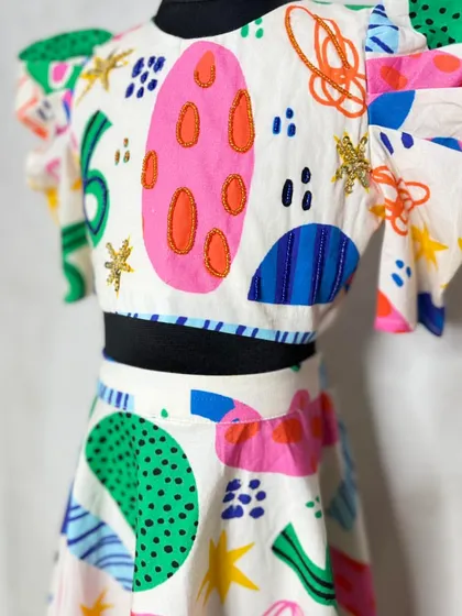 A close-up of the "Fun Shapes" lehenga, showing the fun embroidery details that add a touch of sparkle to the colorful, abstract print.