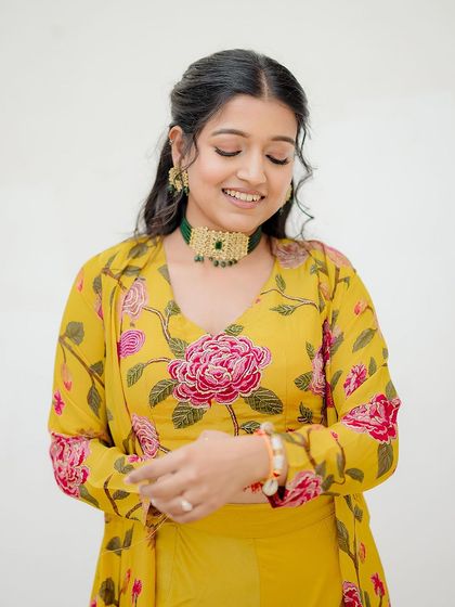 A lovely solo portrait of the bride-to-be, her floral outfit and gentle smile radiating warmth and happiness.