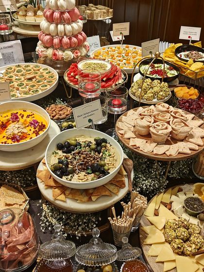 Every element is thoughtfully placed to create a visually stunning landscape of food. This setup includes our popular black olive tapenade and sun-dried tomato dip.