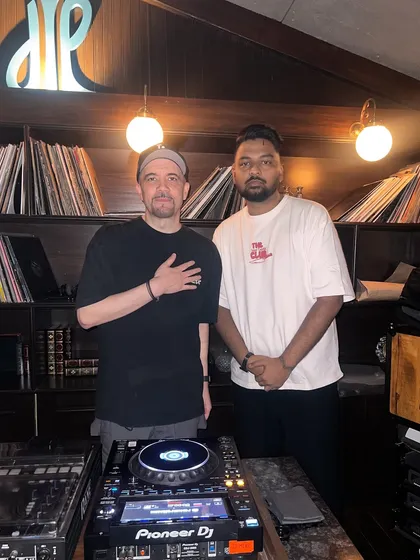 Behind the decks with a fellow DJ. Respect for the craft and for other artists is fundamental to the culture.