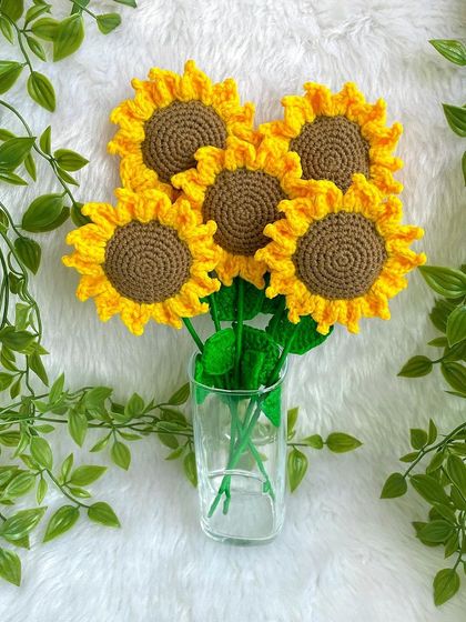 The finished sunflower bouquet placed in a clear glass, showing how these forever flowers can brighten up any space.