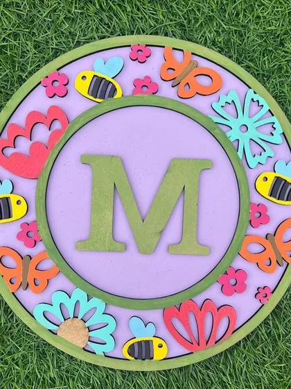 This floral-themed monogram is buzzing with cuteness! Featuring bees, butterflies, and flowers, it's a lovely DIY project that brings a little piece of the garden indoors.