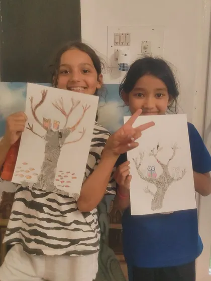 Two friends, our "Crazy Bees," have fun showing off their imaginative tree drawings, one with a castle and the other with an owl.