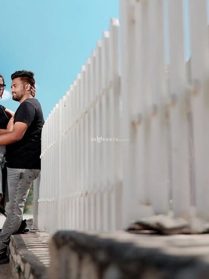 A casual and cool portrait of a couple against a white fence. This shows how we can find great photo opportunities in simple, everyday locations.