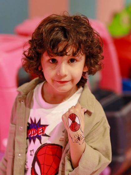 A close-up of the cool Spider-Man tattoo art. We offer fun add-ons like temporary tattoos and face painting to help kids get even more into the party theme.