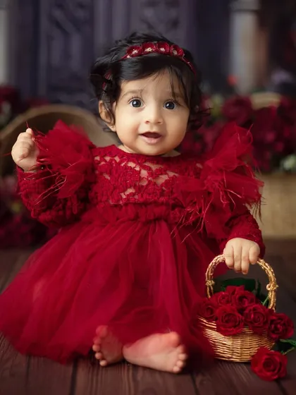 A little lady with her basket of roses. This pose is incredibly sweet and highlights the beautiful details of the red-themed photoshoot.