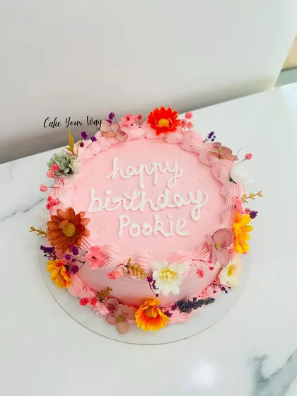 A beautiful floral cake in shades of pink, perfect for a special birthday.