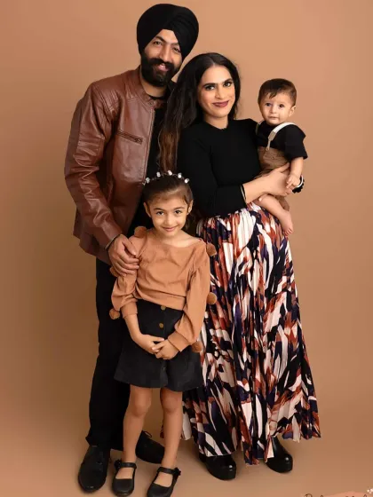 A full-length family portrait in the studio. I help guide you into poses that feel natural and look great, ensuring everyone is comfortable and smiling.
