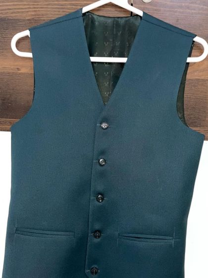 This is the waistcoat that goes with the dark teal blazer from my collection. I ensure that all pieces of a suit, including the waistcoat, are tailored to perfection.
