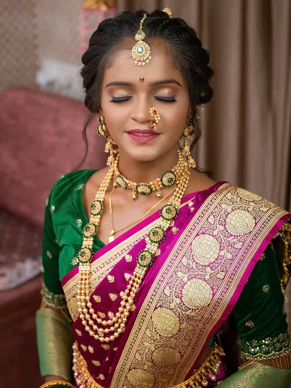 A close-up of a student's work, showcasing a flawless base and beautiful eye makeup on this Maharashtrian bridal look.